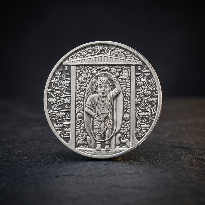 999 purity Shrinathji silver coin with intricate nathdwara haveli design on a dark background