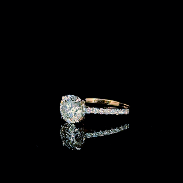 Round cut pavé shank solitaire ring, front-facing view of stone